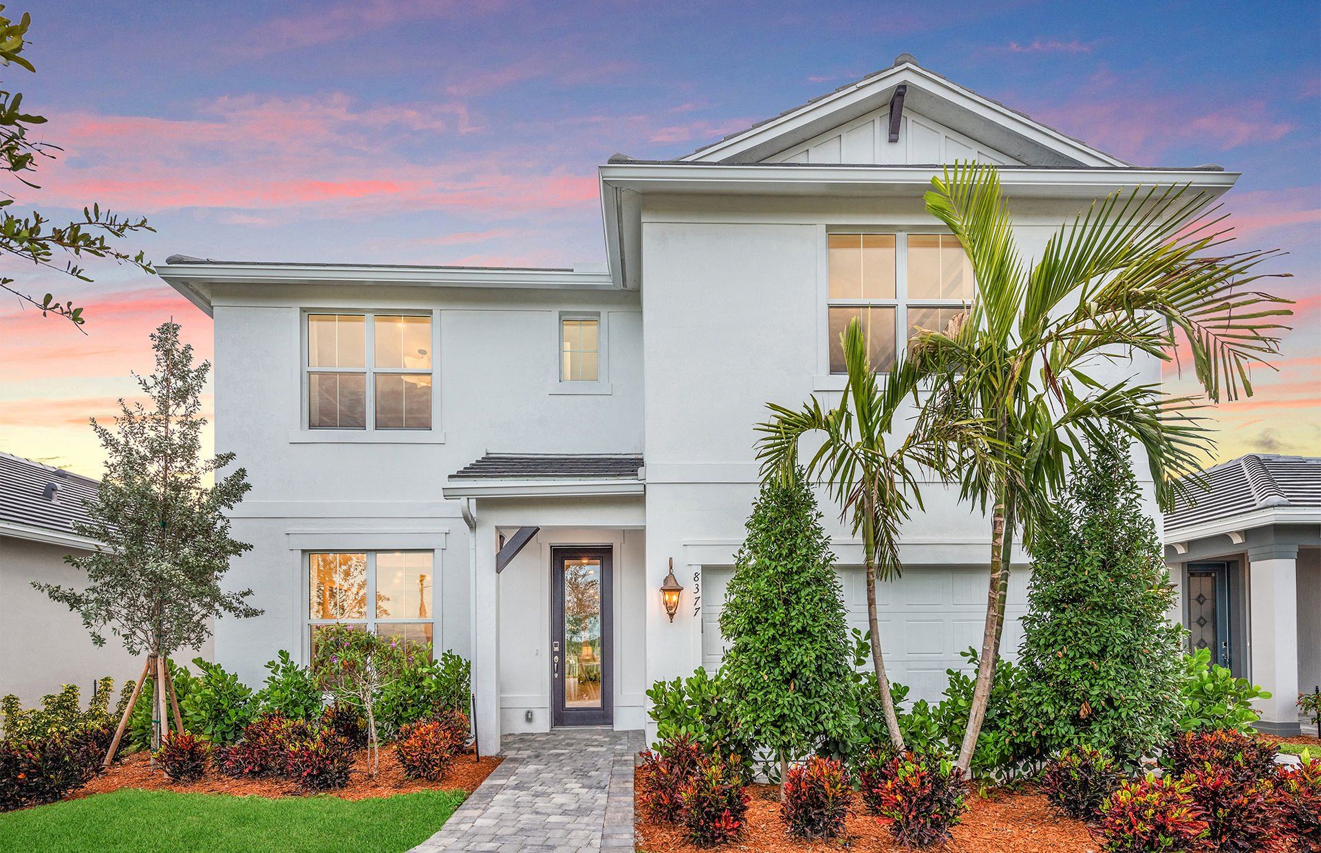 Front exterior of a new home in Harbor Isle, Vero Beach, FL, highlighting curb appeal (Image 1).