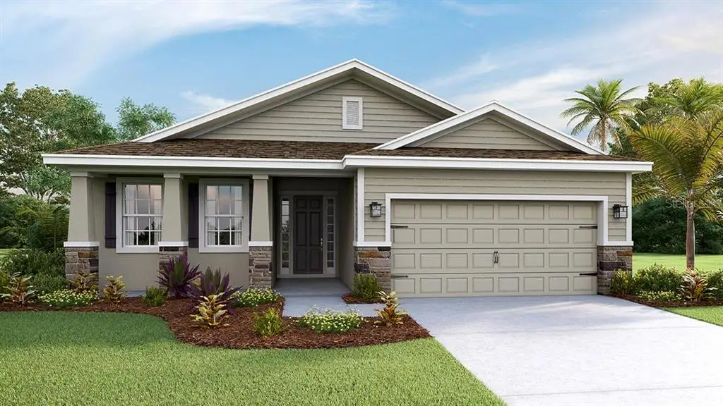 Front exterior of a new home in Twisted Oaks, Wildwood, FL, highlighting curb appeal (Image 1).