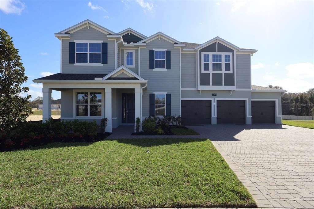 Front exterior of a new home in Willow Run, Apopka, FL, highlighting curb appeal (Image 1). Front exterior of a new home in Willow Run, Apopka, FL, highlighting curb appeal (Image 1).