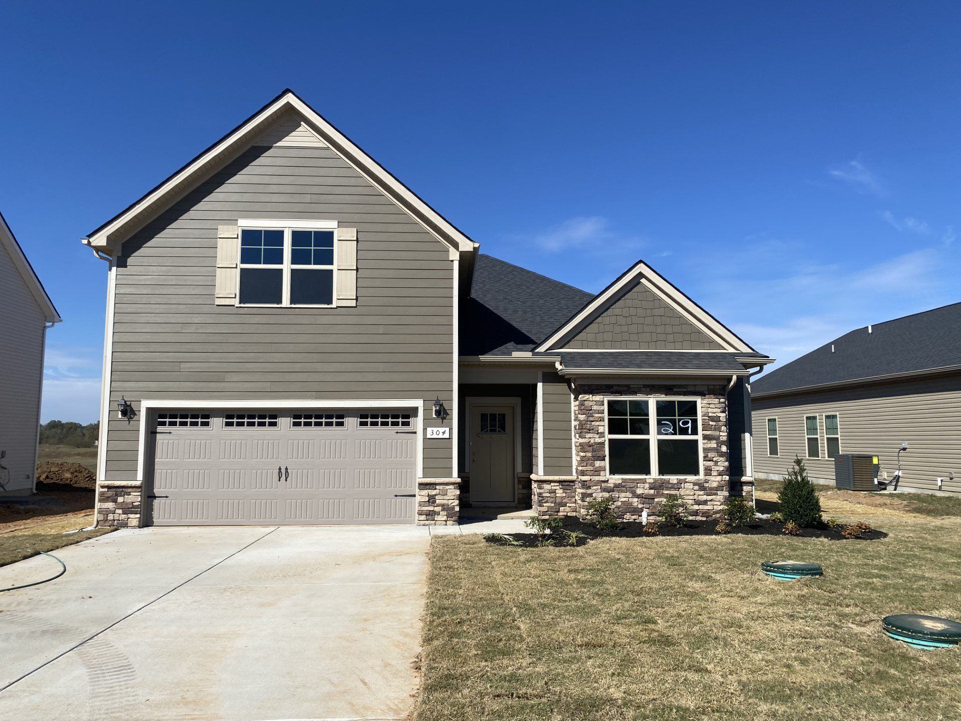 Front exterior of a new home in Woodruff Cove, Murfreesboro, TN, highlighting curb appeal (Image 1). Front exterior of a new home in Woodruff Cove, Murfreesboro, TN, highlighting curb appeal (Image 1).