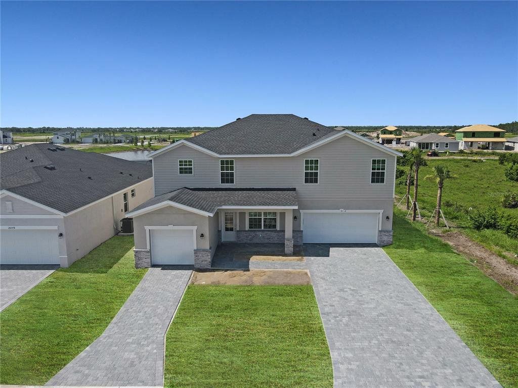 Front exterior of a new home in Lennar at Turnleaf: Manor Homes, Punta Gorda, FL, highlighting curb appeal (Image 1).