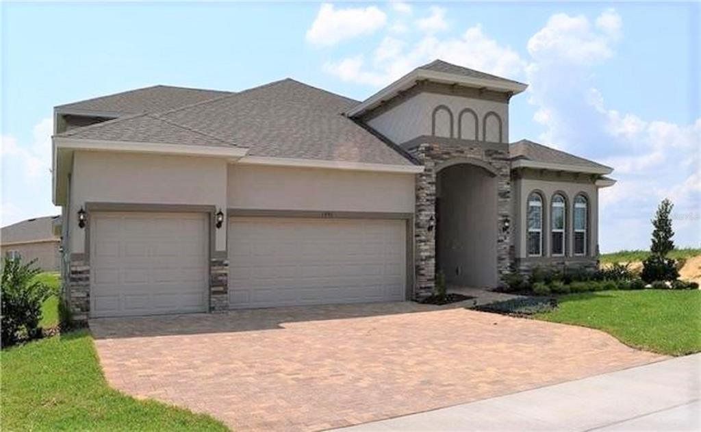 Front exterior of a new home in Hills of Minneola, Minneola, FL, highlighting curb appeal (Image 1). Front exterior of a new home in Hills of Minneola, Minneola, FL, highlighting curb appeal (Image 1).