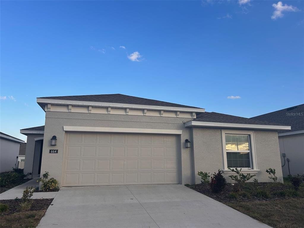 Front exterior of a new home in Lawson Dunes, Haines City, FL, highlighting curb appeal (Image 1). Front exterior of a new home in Lawson Dunes, Haines City, FL, highlighting curb appeal (Image 1).