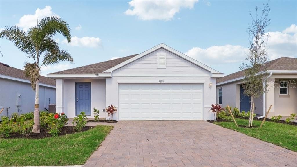 Front exterior of a new home in Driftwood Bay, Port Charlotte, FL, highlighting curb appeal (Image 1). Front exterior of a new home in Driftwood Bay, Port Charlotte, FL, highlighting curb appeal (Image 1).