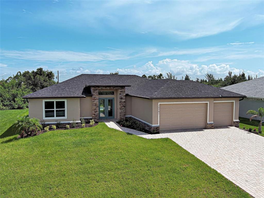 Front exterior of a new home in , Port Charlotte, FL, highlighting curb appeal (Image 1). Front exterior of a new home in , Port Charlotte, FL, highlighting curb appeal (Image 1).