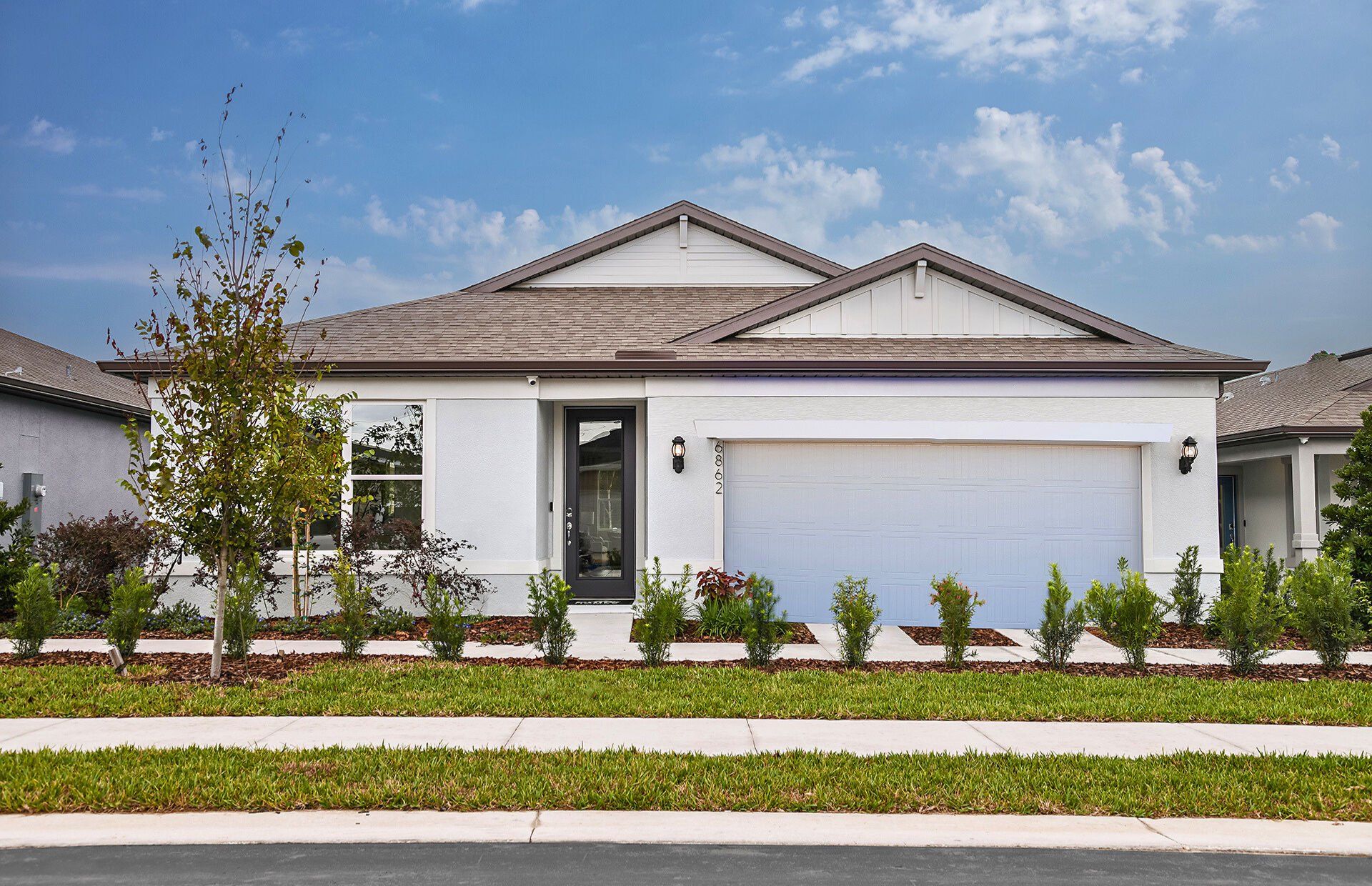 Front exterior of a new home in Twisted Oaks, Wildwood, FL, highlighting curb appeal (Image 1).