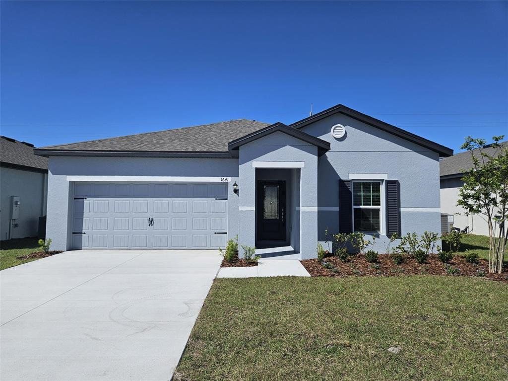 Front exterior of a new home in Peach Crossings, Winter Haven, FL, highlighting curb appeal (Image 1).