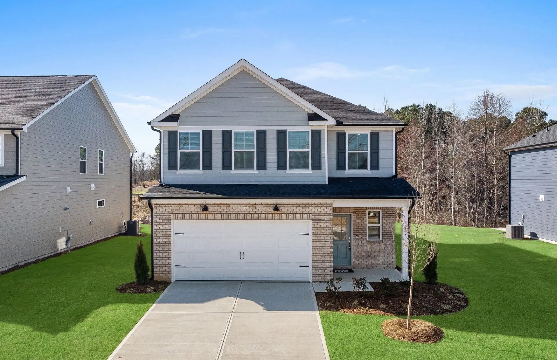 Front exterior of a new home in Providence Oaks, Fuquay Varina, NC, highlighting curb appeal (Image 1). Front exterior of a new home in Providence Oaks, Fuquay Varina, NC, highlighting curb appeal (Image 1).