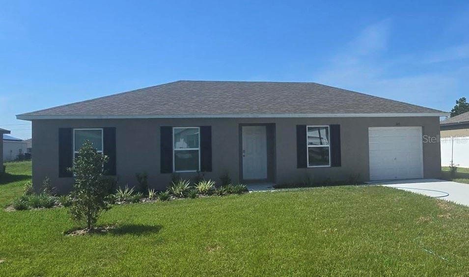 Front exterior of a new home in Poinciana, Poinciana, FL, highlighting curb appeal (Image 1).