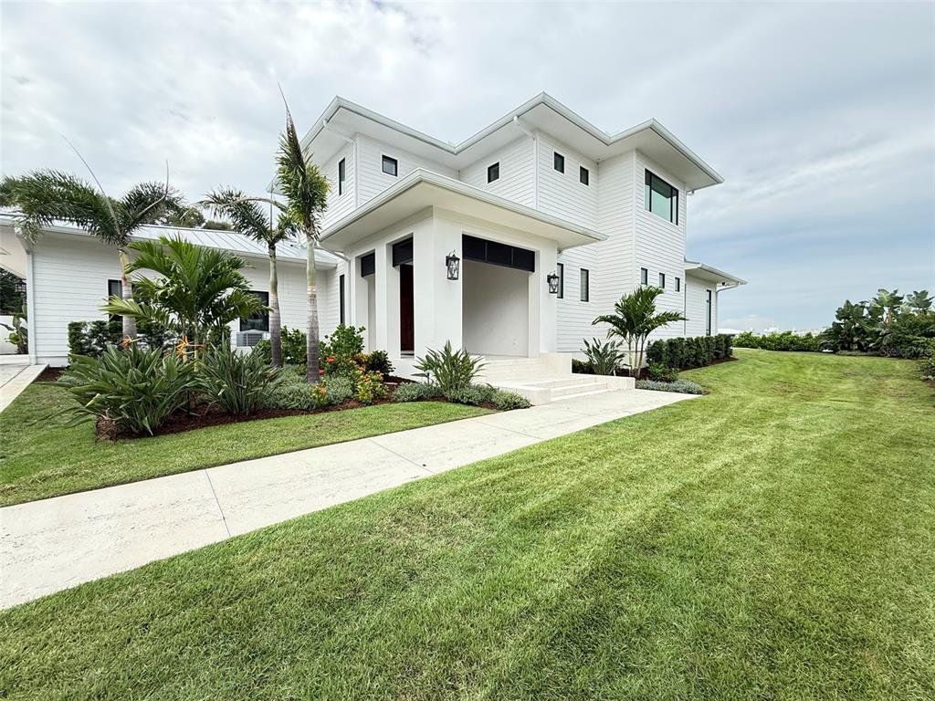 Front exterior of a new home in , New Smyrna Beach, FL, highlighting curb appeal (Image 1). Front exterior of a new home in , New Smyrna Beach, FL, highlighting curb appeal (Image 1).