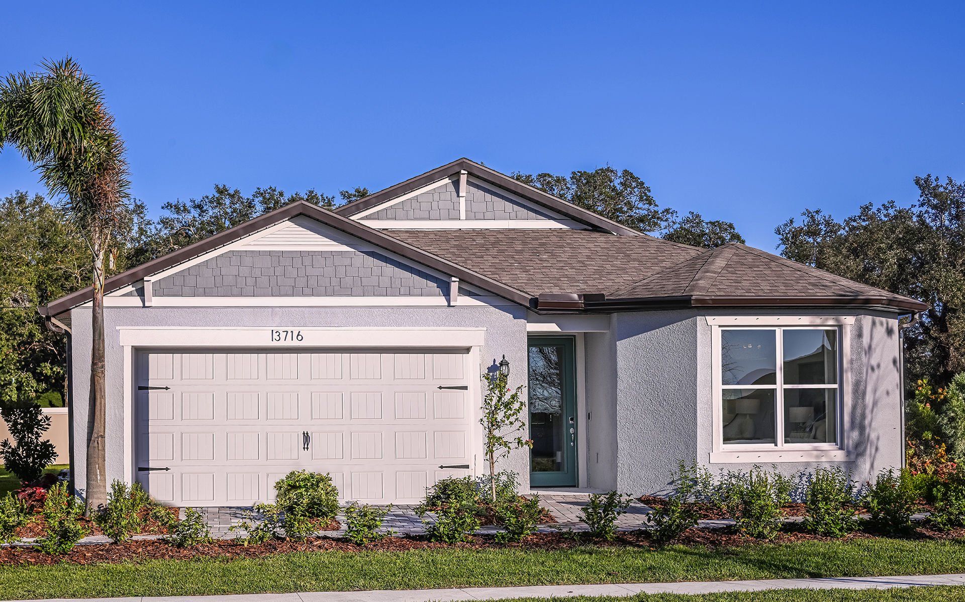 Front exterior of a new home in Spencer Glen, Riverview, FL, highlighting curb appeal (Image 1). Front exterior of a new home in Spencer Glen, Riverview, FL, highlighting curb appeal (Image 1).