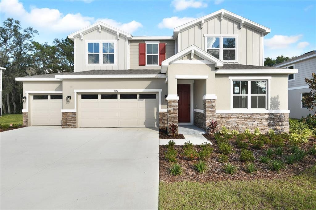 Front exterior of a new home in Seasons at Wekiva Ridge, Mount Dora, FL, highlighting curb appeal (Image 1). Front exterior of a new home in Seasons at Wekiva Ridge, Mount Dora, FL, highlighting curb appeal (Image 1).