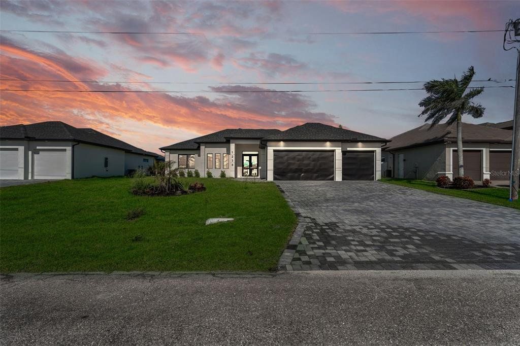 Front exterior of a new home in , Cape Coral, FL, highlighting curb appeal (Image 1). Front exterior of a new home in , Cape Coral, FL, highlighting curb appeal (Image 1).