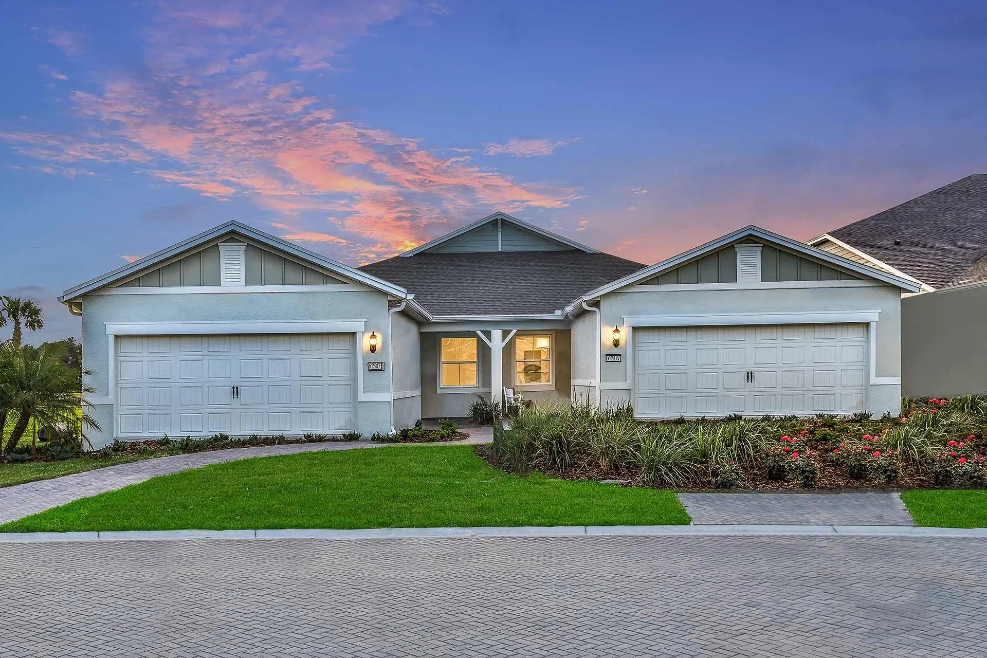 Front exterior of a new home in Del Webb Sunbridge, St. Cloud, FL, highlighting curb appeal (Image 1).