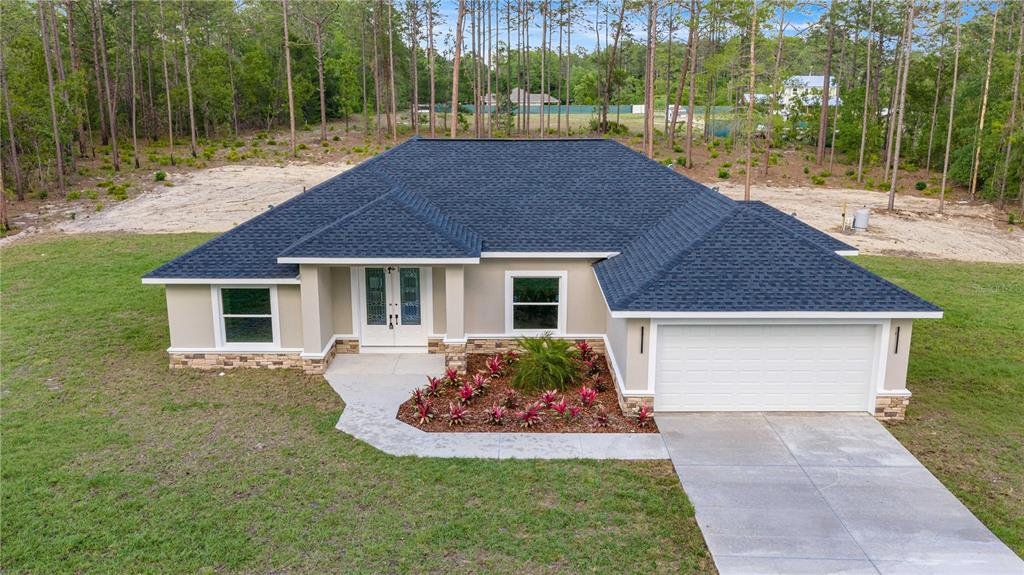 Front exterior of a new home in , Ocala, FL, highlighting curb appeal (Image 1). Front exterior of a new home in , Ocala, FL, highlighting curb appeal (Image 1).