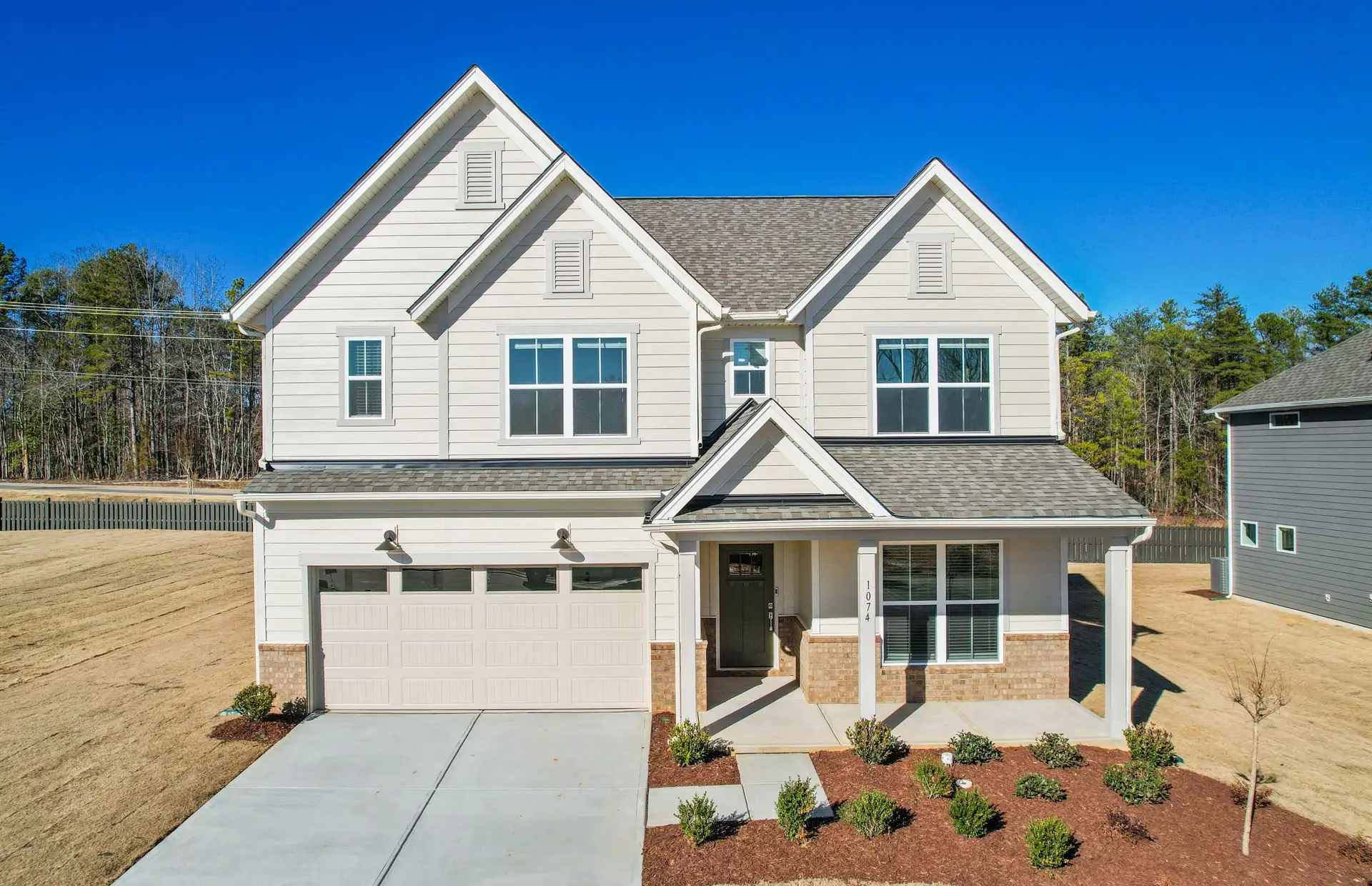 Front exterior of a new home in Elmbrook, Indian Trail, NC, highlighting curb appeal (Image 1). Front exterior of a new home in Elmbrook, Indian Trail, NC, highlighting curb appeal (Image 1).