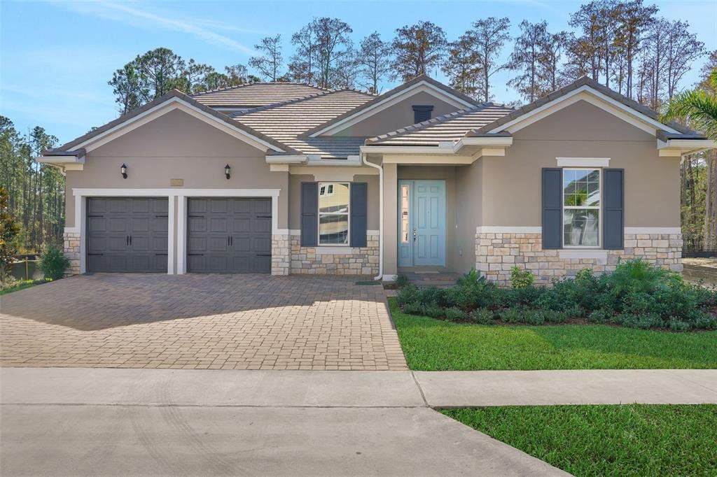 Front exterior of a new home in Palms at Windermere, Windermere, FL, highlighting curb appeal (Image 1). Front exterior of a new home in Palms at Windermere, Windermere, FL, highlighting curb appeal (Image 1).