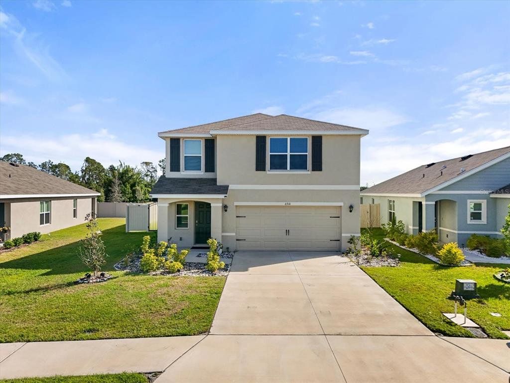 Front exterior of a new home in Silverstone North, Palmetto, FL, highlighting curb appeal (Image 1). Front exterior of a new home in Silverstone North, Palmetto, FL, highlighting curb appeal (Image 1).