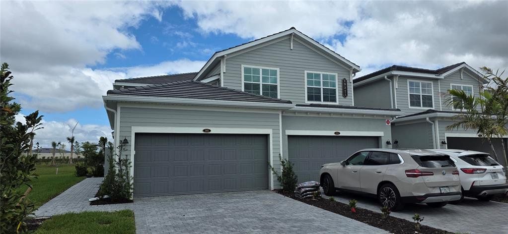 Front exterior of a new home in Calusa Country Club, Lakewood Ranch, FL, highlighting curb appeal (Image 1). Front exterior of a new home in Calusa Country Club, Lakewood Ranch, FL, highlighting curb appeal (Image 1).