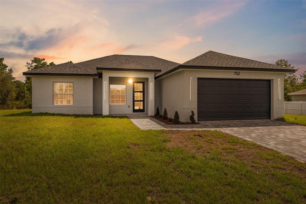 Front exterior of a new home in , Ocala, FL, highlighting curb appeal (Image 1). Front exterior of a new home in , Ocala, FL, highlighting curb appeal (Image 1).