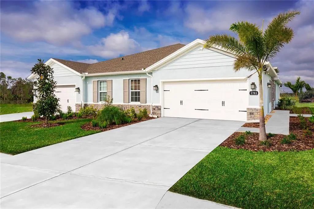 Front exterior of a new home in Hammock Oaks Villas, Lady Lake, FL, highlighting curb appeal (Image 1). Front exterior of a new home in Hammock Oaks Villas, Lady Lake, FL, highlighting curb appeal (Image 1).