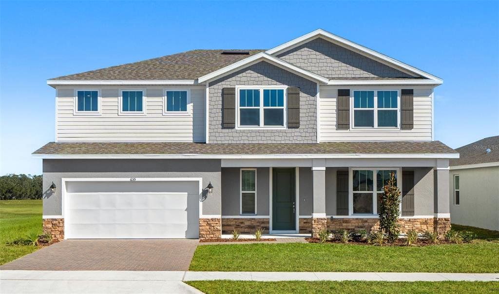 Front exterior of a new home in Eden Crest, Apopka, FL, highlighting curb appeal (Image 1). Front exterior of a new home in Eden Crest, Apopka, FL, highlighting curb appeal (Image 1).