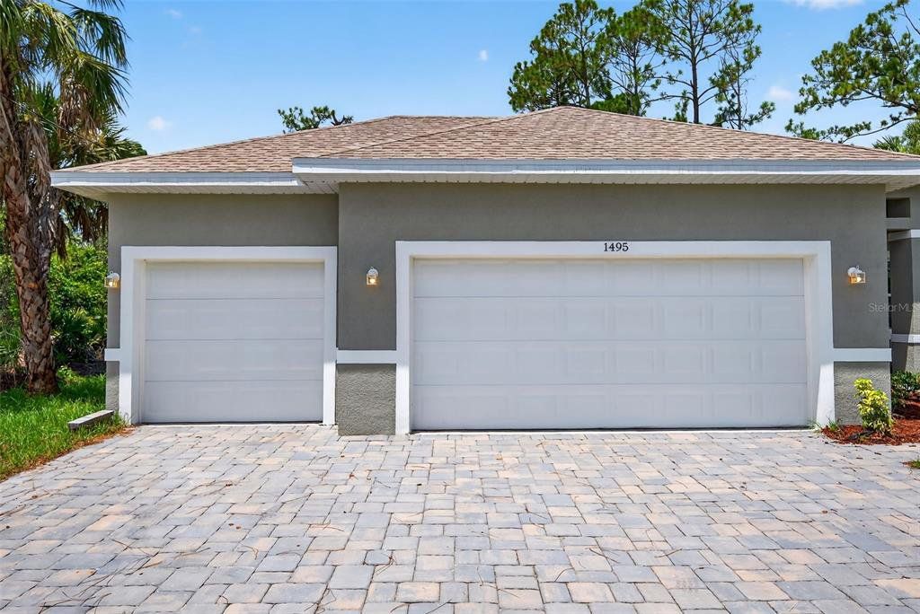 Front exterior of a new home in , North Port, FL, highlighting curb appeal (Image 1).