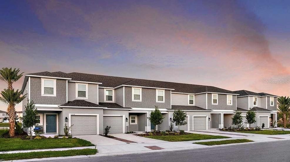 Front exterior of a new home in The Townhomes at Azario Lakewood Ranch, Bradenton, FL, highlighting curb appeal (Image 1). Front exterior of a new home in The Townhomes at Azario Lakewood Ranch, Bradenton, FL, highlighting curb appeal (Image 1).