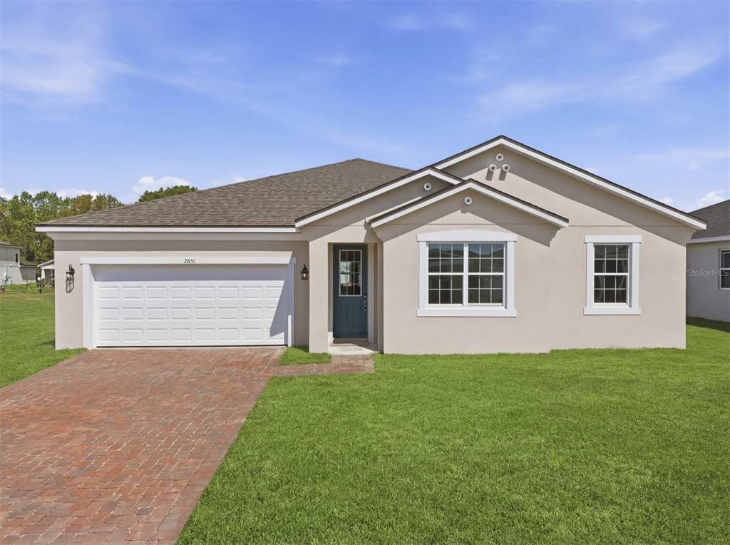 Front exterior of a new home in Meadowlark Landing, Apopka, FL, highlighting curb appeal (Image 1). Front exterior of a new home in Meadowlark Landing, Apopka, FL, highlighting curb appeal (Image 1).