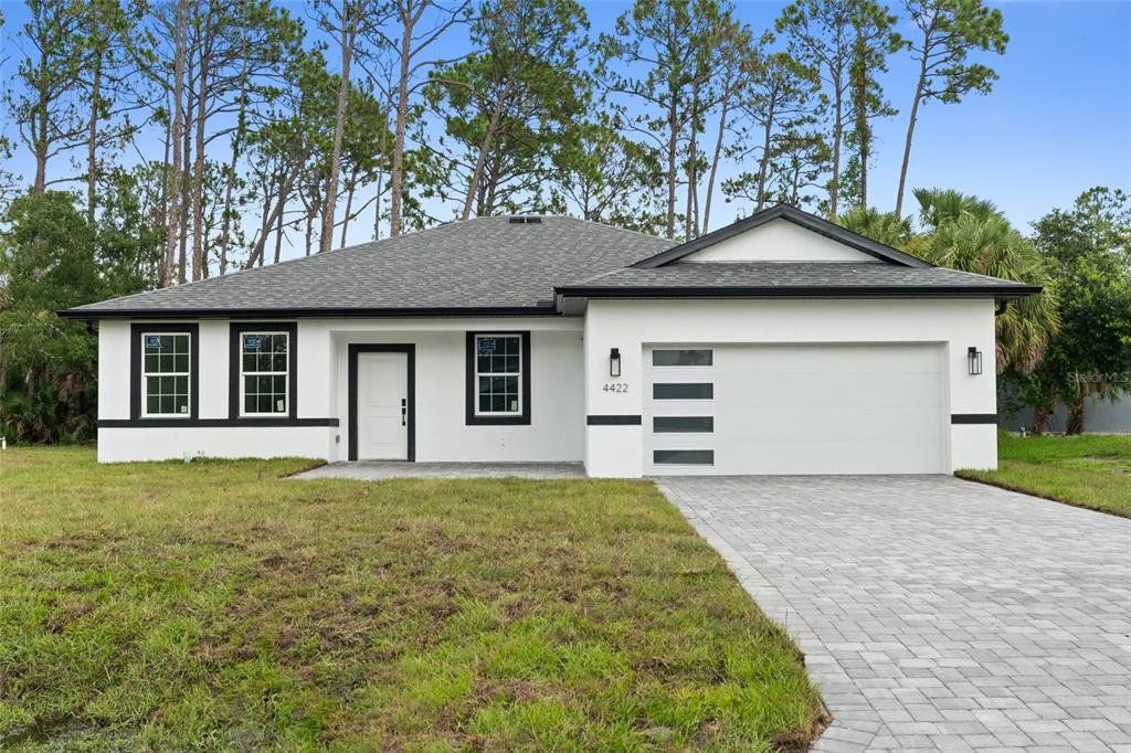 Front exterior of a new home in , North Port, FL, highlighting curb appeal (Image 1). Front exterior of a new home in , North Port, FL, highlighting curb appeal (Image 1).