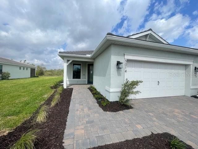 Front exterior of a new home in Del Webb Catalina, Lakewood Ranch, FL, highlighting curb appeal (Image 1).