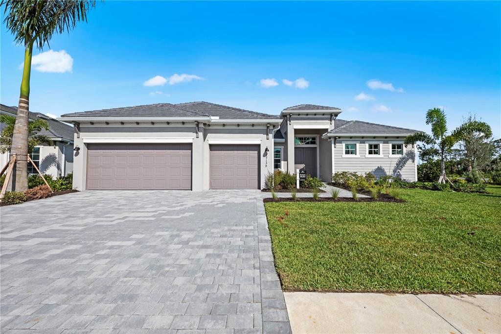 Front exterior of a new home in South Gulf Cove, Port Charlotte, FL, highlighting curb appeal (Image 1).