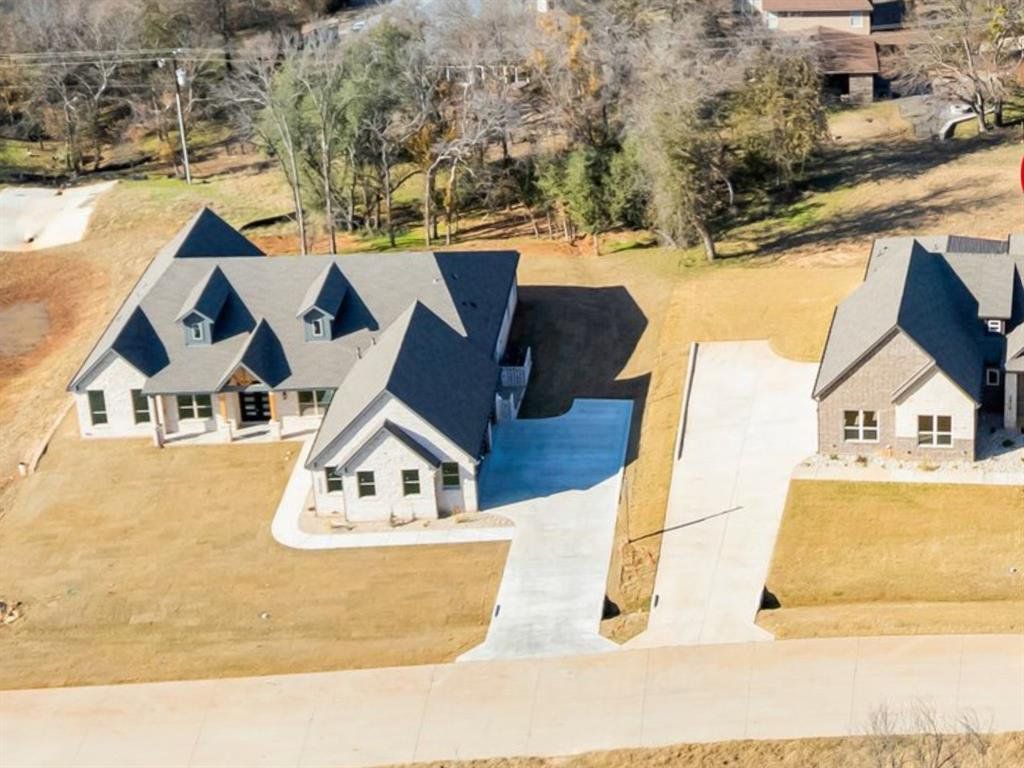 Front exterior of a new home in , Granbury, TX, highlighting curb appeal (Image 1). Front exterior of a new home in , Granbury, TX, highlighting curb appeal (Image 1).