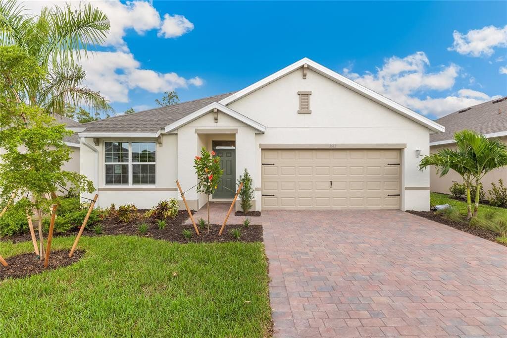 Front exterior of a new home in Seagrass - Express & Tradition, Punta Gorda, FL, highlighting curb appeal (Image 1). Front exterior of a new home in Seagrass - Express & Tradition, Punta Gorda, FL, highlighting curb appeal (Image 1).
