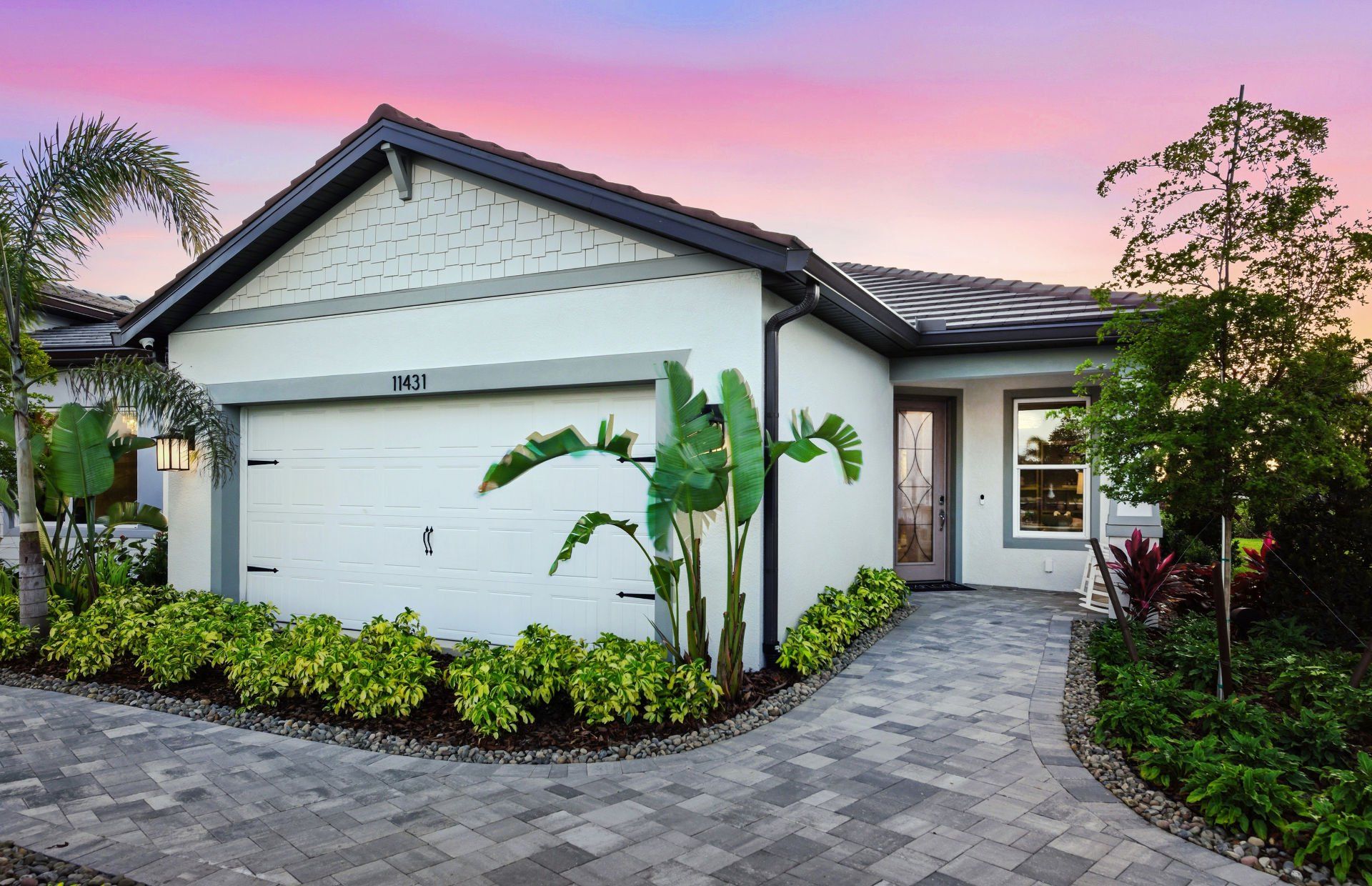 Front exterior of a new home in Explore North River Ranch, Parrish, FL, highlighting curb appeal (Image 1). Front exterior of a new home in Explore North River Ranch, Parrish, FL, highlighting curb appeal (Image 1).