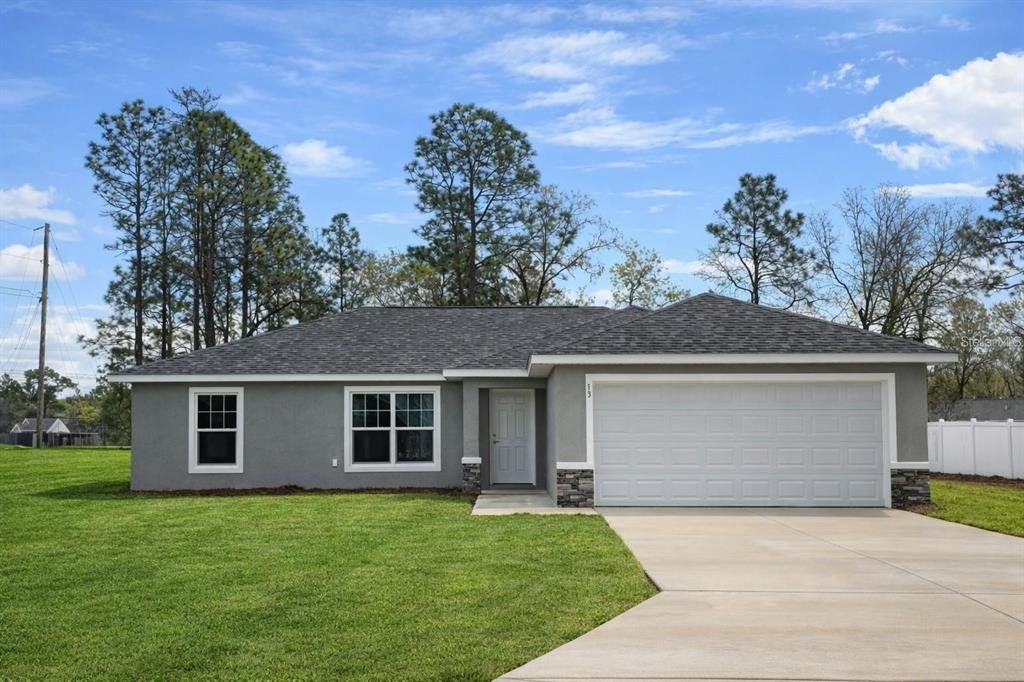 Front exterior of a new home in , Summerfield, FL, highlighting curb appeal (Image 1). Front exterior of a new home in , Summerfield, FL, highlighting curb appeal (Image 1).