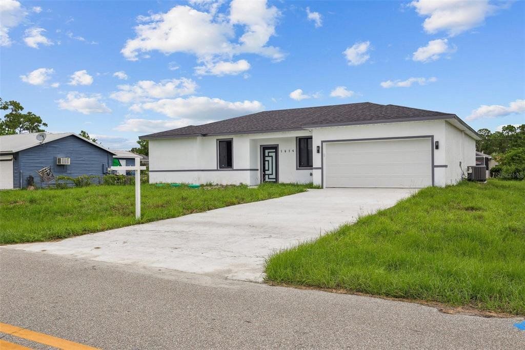 Front exterior of a new home in , Port Charlotte, FL, highlighting curb appeal (Image 1). Front exterior of a new home in , Port Charlotte, FL, highlighting curb appeal (Image 1).