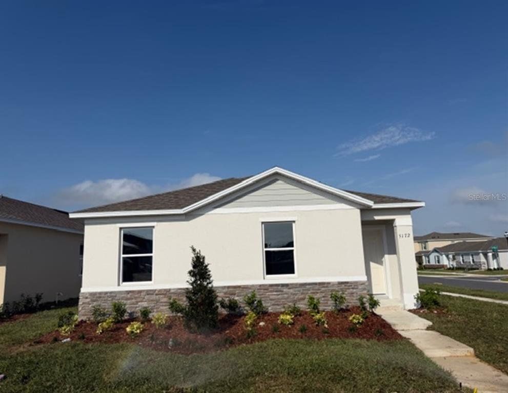 Front exterior of a new home in Crossroads at Kelly Park, Apopka, FL, highlighting curb appeal (Image 1). Front exterior of a new home in Crossroads at Kelly Park, Apopka, FL, highlighting curb appeal (Image 1).