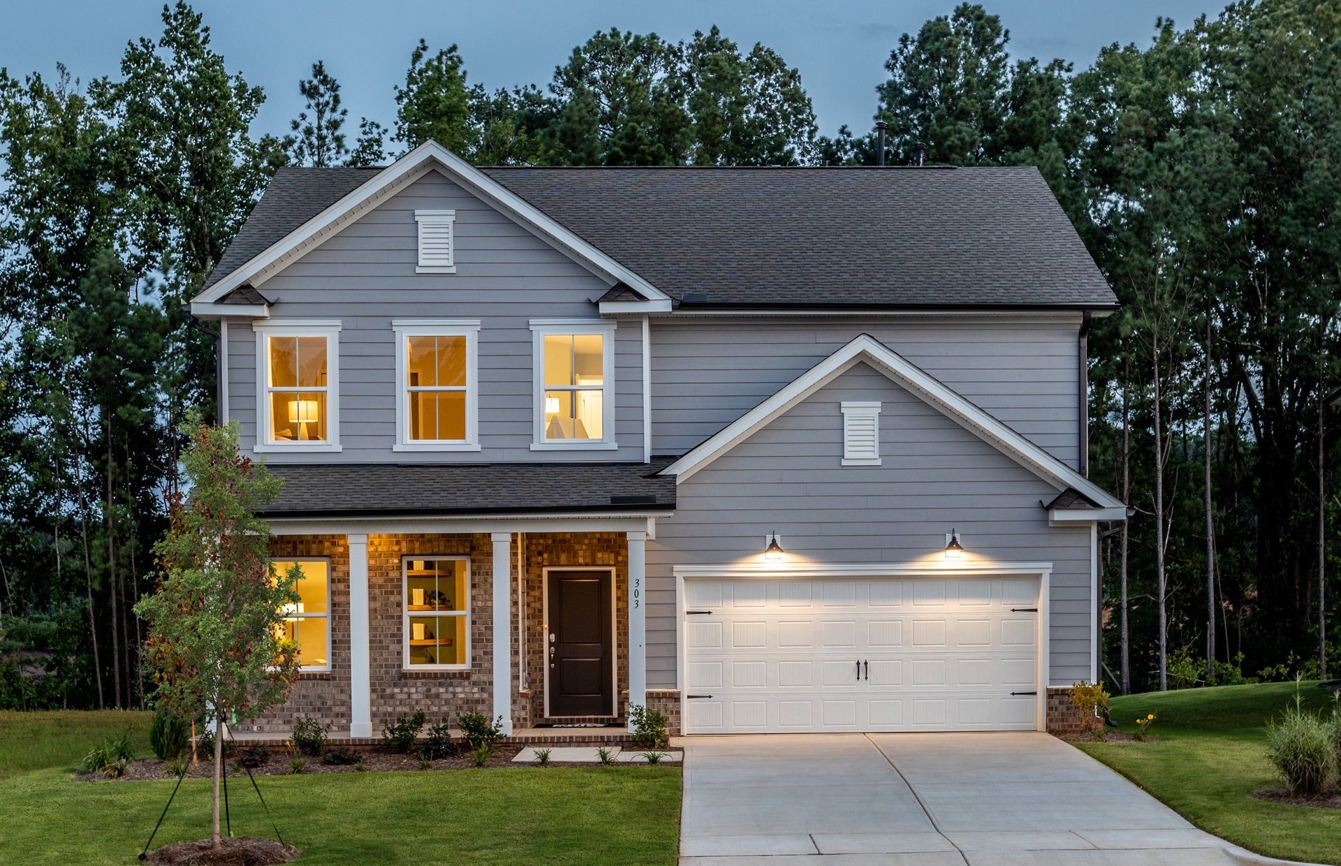 Front exterior of a new home in Exchange at 401, Raleigh, NC, highlighting curb appeal (Image 1). Front exterior of a new home in Exchange at 401, Raleigh, NC, highlighting curb appeal (Image 1).