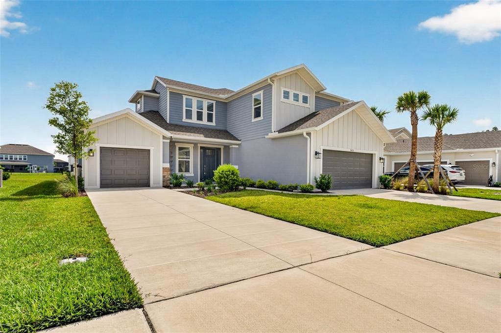 Front exterior of a new home in River Landing, Wesley Chapel, FL, highlighting curb appeal (Image 1). Front exterior of a new home in River Landing, Wesley Chapel, FL, highlighting curb appeal (Image 1).