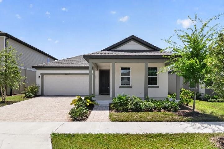 Front exterior of a new home in Hawks Run, Kissimmee, FL, highlighting curb appeal (Image 1). Front exterior of a new home in Hawks Run, Kissimmee, FL, highlighting curb appeal (Image 1).
