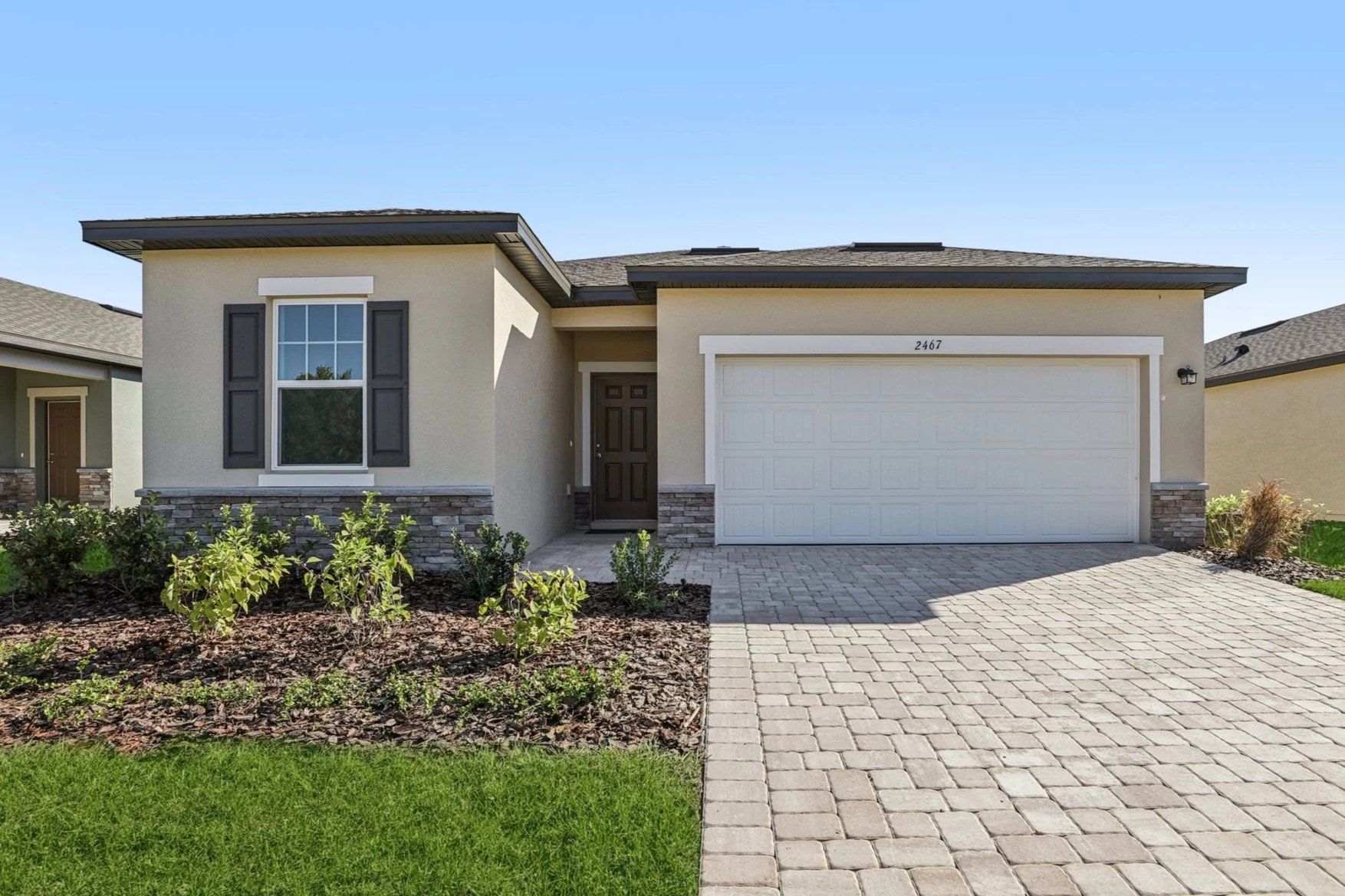 Front exterior of a new home in Hawks Run, Kissimmee, FL, highlighting curb appeal (Image 1).