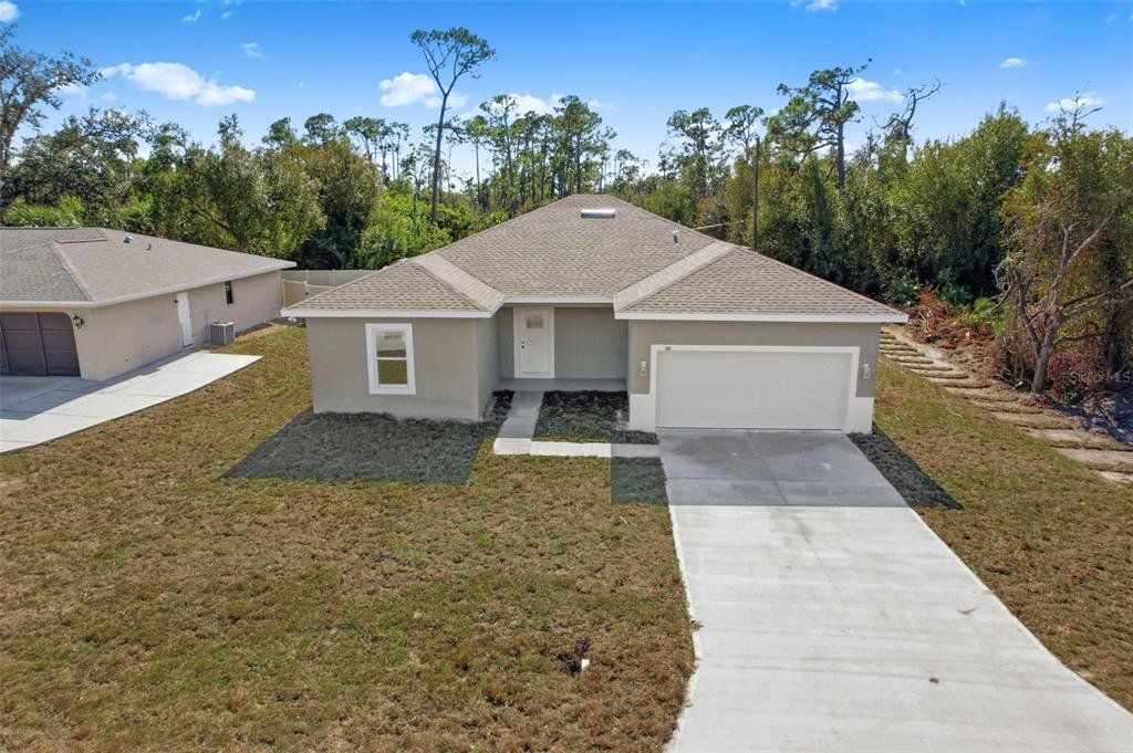 Front exterior of a new home in , Port Charlotte, FL, highlighting curb appeal (Image 1). Front exterior of a new home in , Port Charlotte, FL, highlighting curb appeal (Image 1).