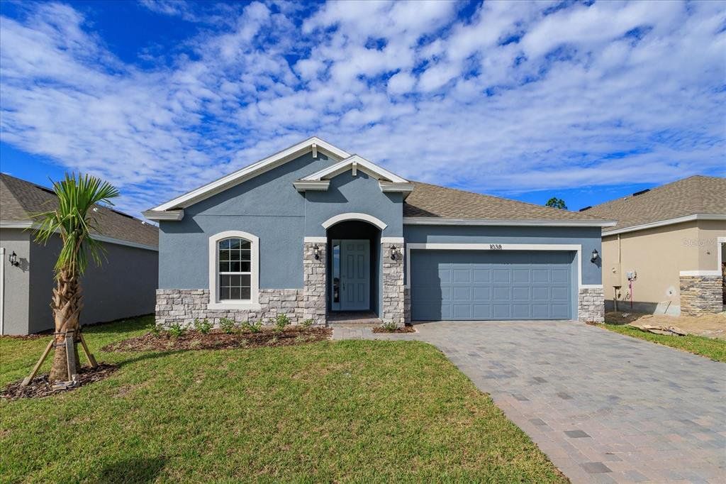 Front exterior of a new home in Cypress Park Estates, Haines City, FL, highlighting curb appeal (Image 1). Front exterior of a new home in Cypress Park Estates, Haines City, FL, highlighting curb appeal (Image 1).