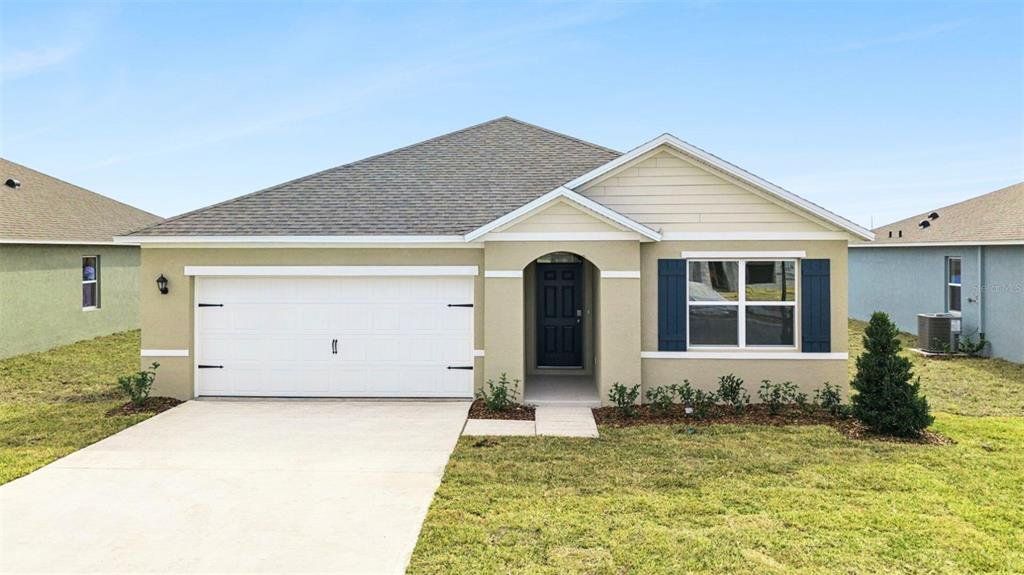Front exterior of a new home in Oak Leaf Preserve, New Smyrna Beach, FL, highlighting curb appeal (Image 1). Front exterior of a new home in Oak Leaf Preserve, New Smyrna Beach, FL, highlighting curb appeal (Image 1).