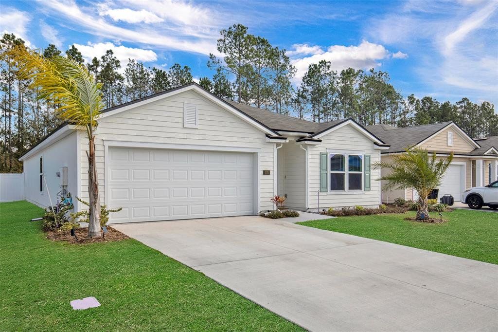 Front exterior of a new home in Sawmill Branch, Palm Coast, FL, highlighting curb appeal (Image 1). Front exterior of a new home in Sawmill Branch, Palm Coast, FL, highlighting curb appeal (Image 1).