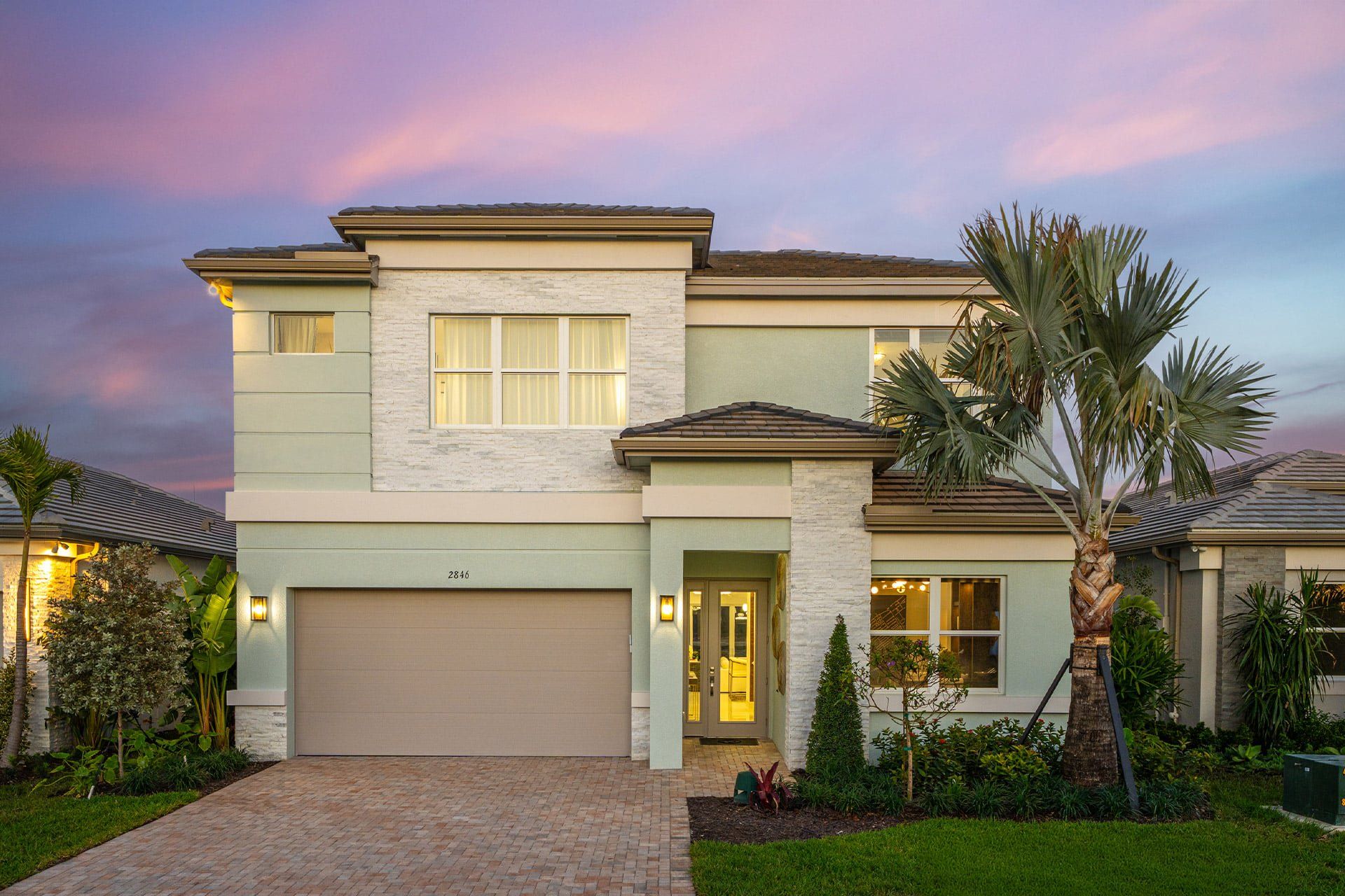 Front exterior of a new home in Valencia Sky (55+), Naples, FL, highlighting curb appeal (Image 1). Front exterior of a new home in Valencia Sky (55+), Naples, FL, highlighting curb appeal (Image 1).