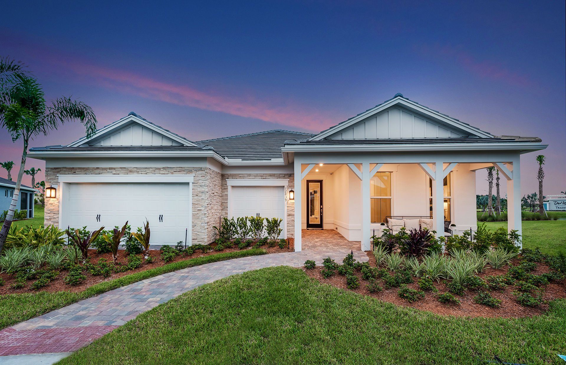 Front exterior of a new home in Del Webb Tradition, Port St. Lucie, FL, highlighting curb appeal (Image 1). Front exterior of a new home in Del Webb Tradition, Port St. Lucie, FL, highlighting curb appeal (Image 1).