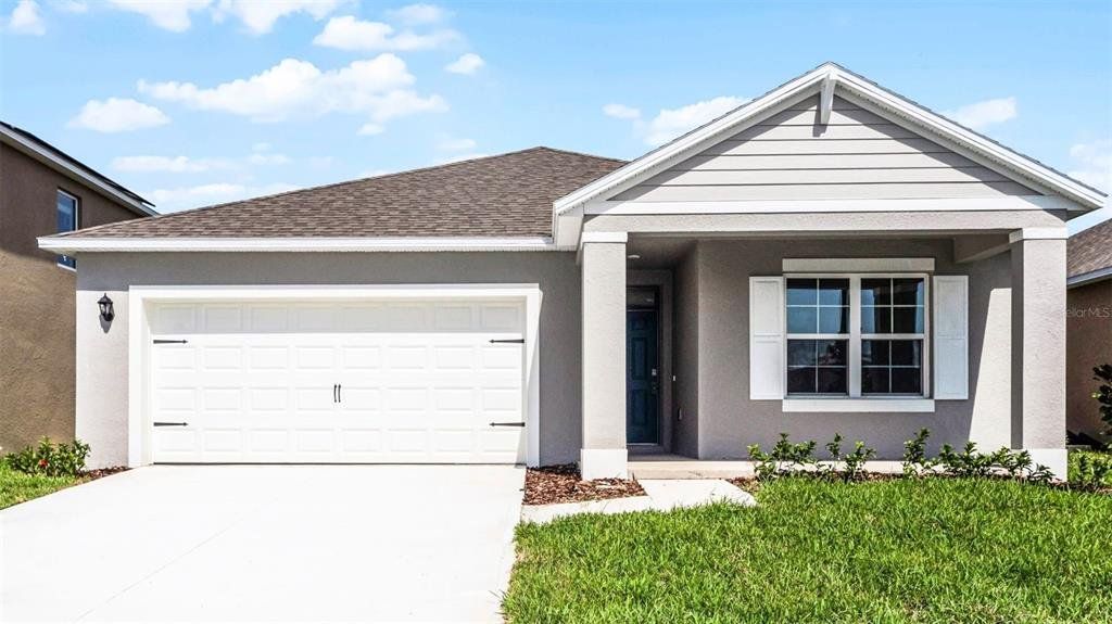 Front exterior of a new home in Crossroads at Kelly Park, Apopka, FL, highlighting curb appeal (Image 1). Front exterior of a new home in Crossroads at Kelly Park, Apopka, FL, highlighting curb appeal (Image 1).