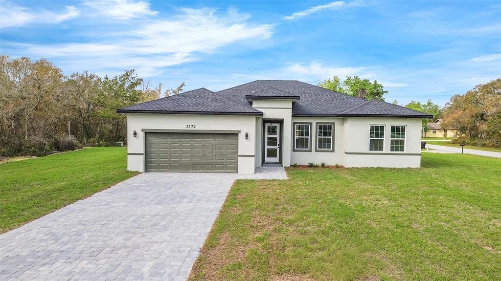 Front exterior of a new home in , Ocala, FL, highlighting curb appeal (Image 1). Front exterior of a new home in , Ocala, FL, highlighting curb appeal (Image 1).
